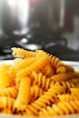 A detailed view of uncooked fusilli pasta on a plate, ideal for food photography.